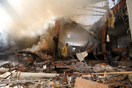 Firefighters try to extinguish a fire at the community hall where Saudi-led warplanes struck a funeral in Sanaa, October 9, 2016. REUTERS/Khaled Abdullah