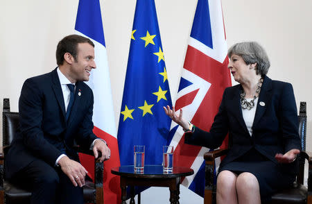 Britain's Prime Minister Theresa May and French President Emmanuel Macron talk during a bilateral meeting at the G7 Summit in Taormina, Sicily, Italy, May 26, 2017. REUTERS/Stephane De Sakutin/Pool