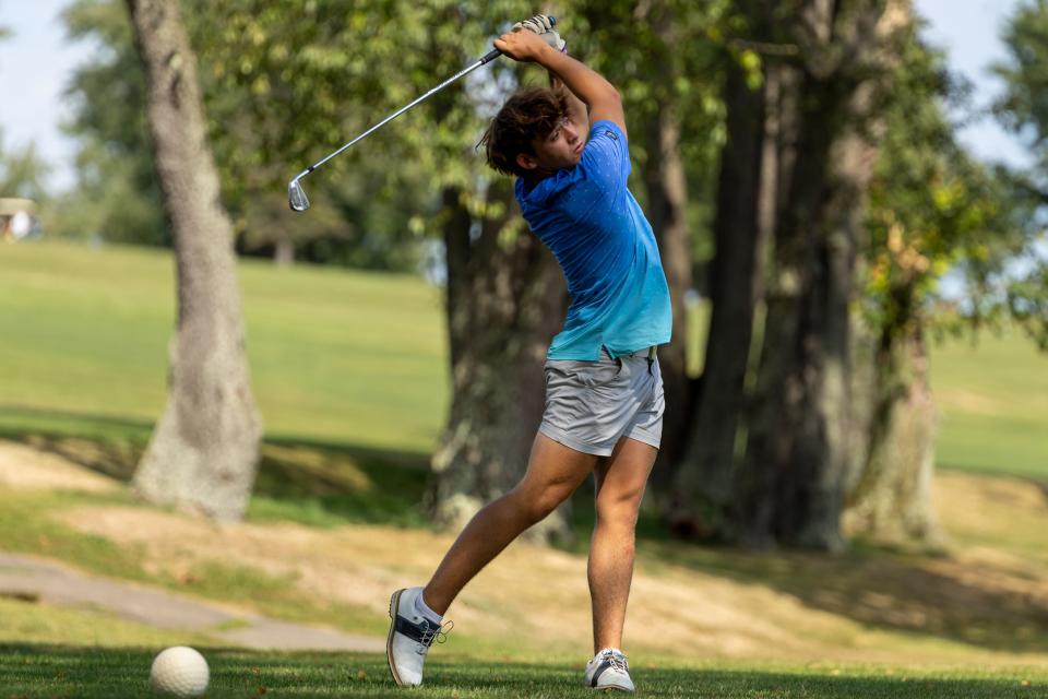 Ellwood City's Jordan Keller watches his ball flight Wednesday during the Wolverines non-section match against Wilmington at Del-Mar Golf Course in Wampum, Pa.