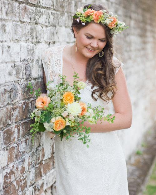 bride posing in her completed diy floral crown