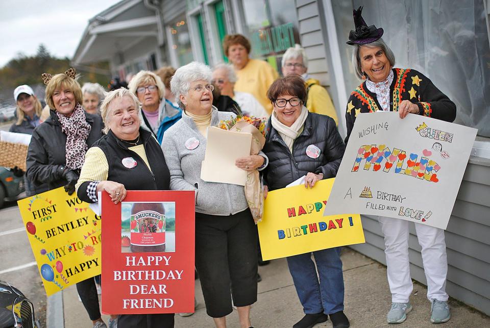 Hingham Senior Center friends of Phyllis Chapman organized a surprise early birthday party in honor of Chapman's 104th birthday on Nov. 5. From left, Jean Silverio, Nancy Richmond,  Karen Johnson and Harriet Carpenter hold signs they made for her on Thursday, Oct. 28, 2021.