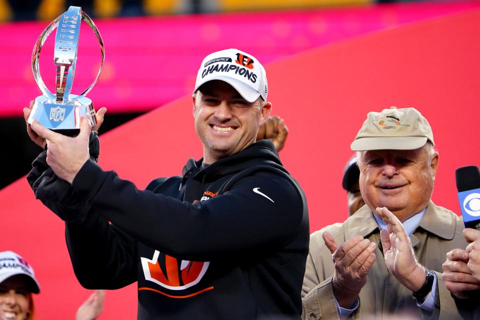 Cincinnati Bengals head coach Zac Taylor raises the AFC Championship trophy next to Cincinnati Bengals President Mike Brown, right, at the conclusion of the AFC championship NFL football game, Sunday, Jan. 30, 2022, at Arrowhead Stadium in Kansas City, Mo.