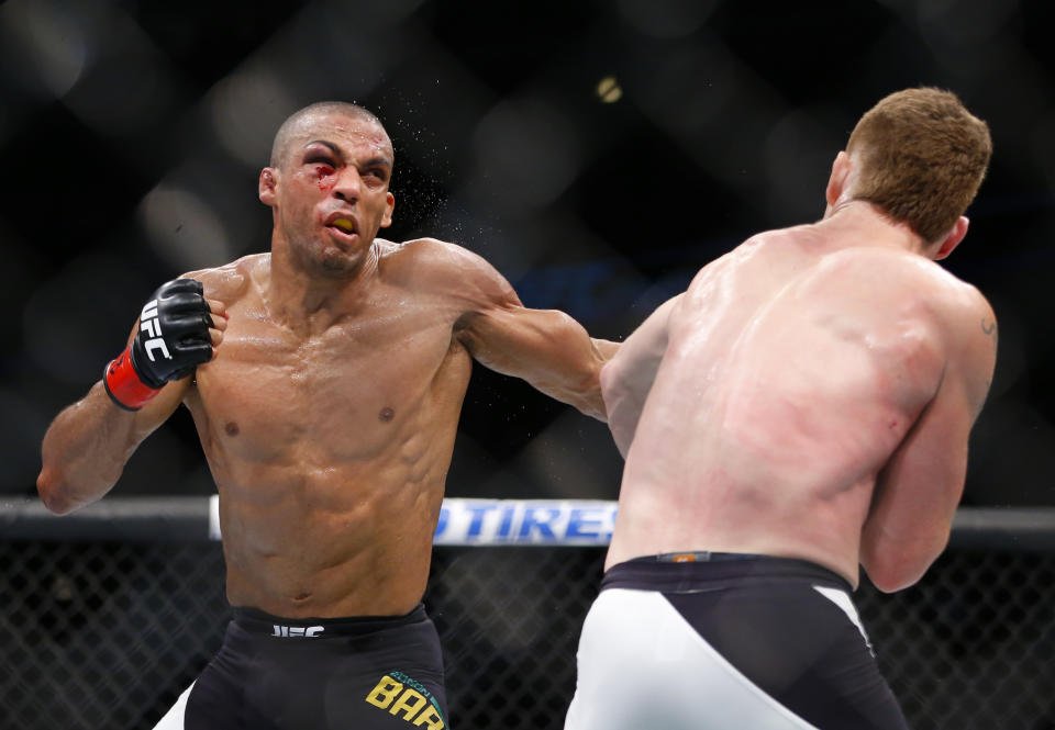 Edson Barboza, left, looks to punch Paul Felder during their lightweight mixed martial arts bout during UFC Chicago on Saturday, July 25, 2015, in Chicago. (AP Photo/Jeff Haynes)