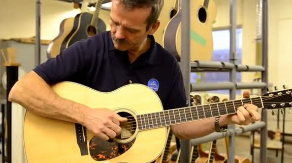 Canadian astronaut Chris Hadfield strums a Larrivée Parlor acoustic guitar similar to the one he will use aboard the International Space Station when he commands orbiting laboratory in 2013 during the Expedition 35 mission.