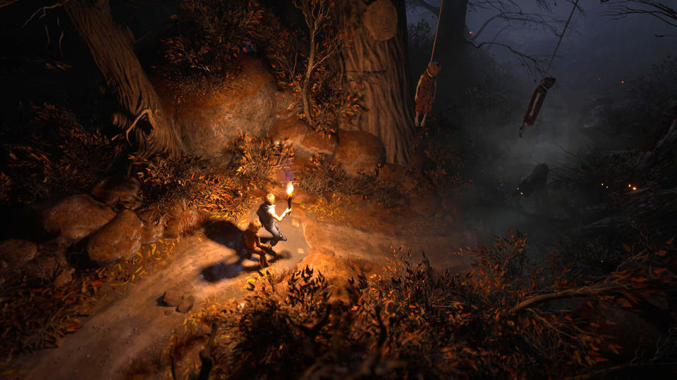 Brothers A Tale of Two Sons Remake review; two characters walk by torch light