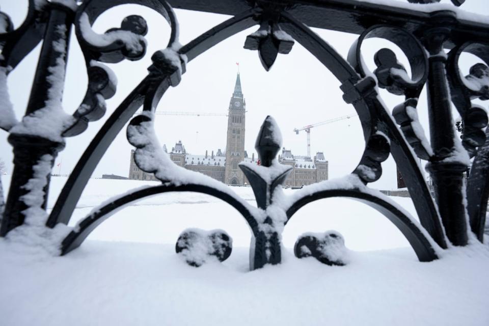 Snow covers a fence surrounding Parliament Hill in Ottawa Jan. 20, 2023.