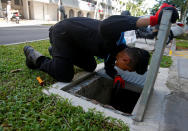 A member of a pest control team inspects drains at a Zika cluster in Singapore September 2, 2016. Picture taken September 2, 2016. REUTERS/Edgar Su