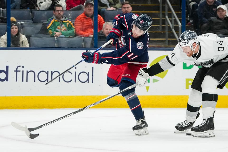 Dec 5, 2023; Columbus, Ohio, USA; Columbus Blue Jackets center Adam Fantilli (11) breaks his stick as he fires a shot in front of Los Angeles Kings defenseman Vladislav Gavrikov (84) during the third period of the NHL game at Nationwide Arena. The Blue Jackets lost 4-3 in overtime.
