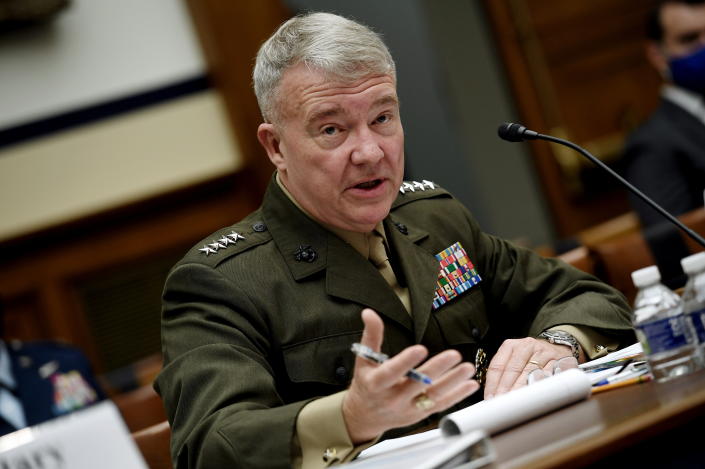 Gen. Kenneth F. McKenzie in full military regalia at the microphone.