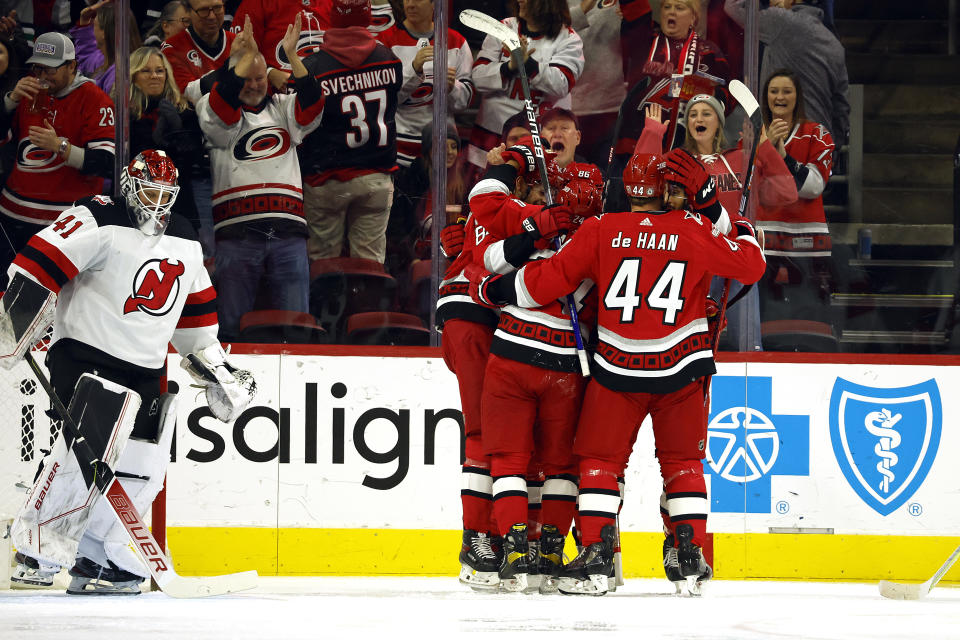 Carolina Hurricanes celebrate a goal by Jesperi Kotkaniemi during the first period of an NHL hockey game against the New Jersey Devils in Raleigh, N.C., Tuesday, Dec. 20, 2022. (AP Photo/Karl B DeBlaker