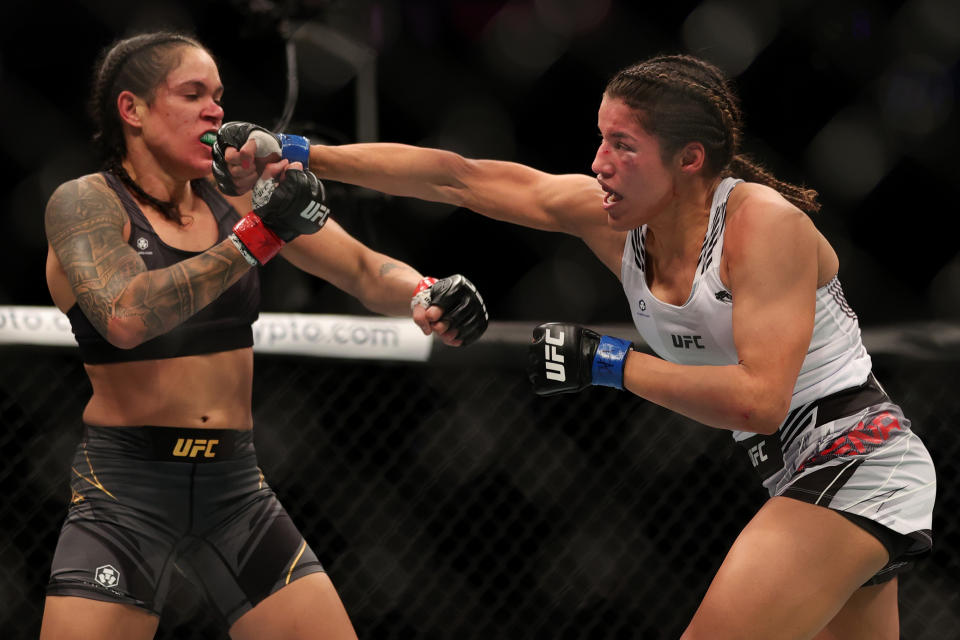 LAS VEGAS, NEVADA - DECEMBER 11: Julianna Pena (R) punches Amanda Nunes of Brazil in their women&#39;s bantamweight title fight during the UFC 269 event at T-Mobile Arena on December 11, 2021 in Las Vegas, Nevada. (Photo by Carmen Mandato/Getty Images)
