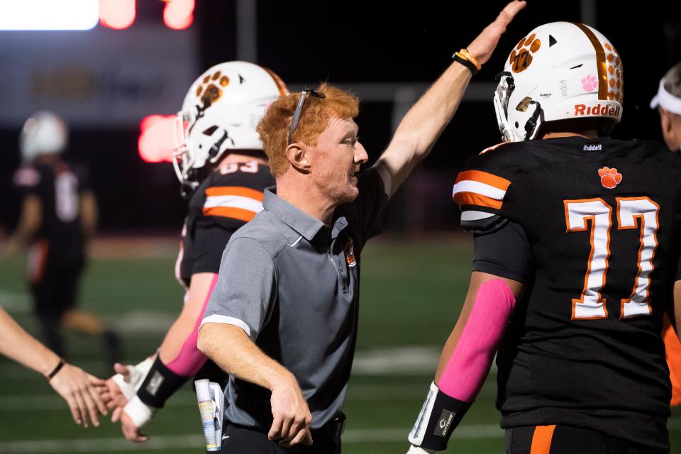 Central York assistant coach Cody Lehmann greets special teams players, including senior Rayden Belle (77), after a successful PAT during a game this season. A 2013 graduate of Central York, Lehmann was born with a rare congenital disorder. He was unable to play contact sports, but he has been devoted to Central athletics for years.