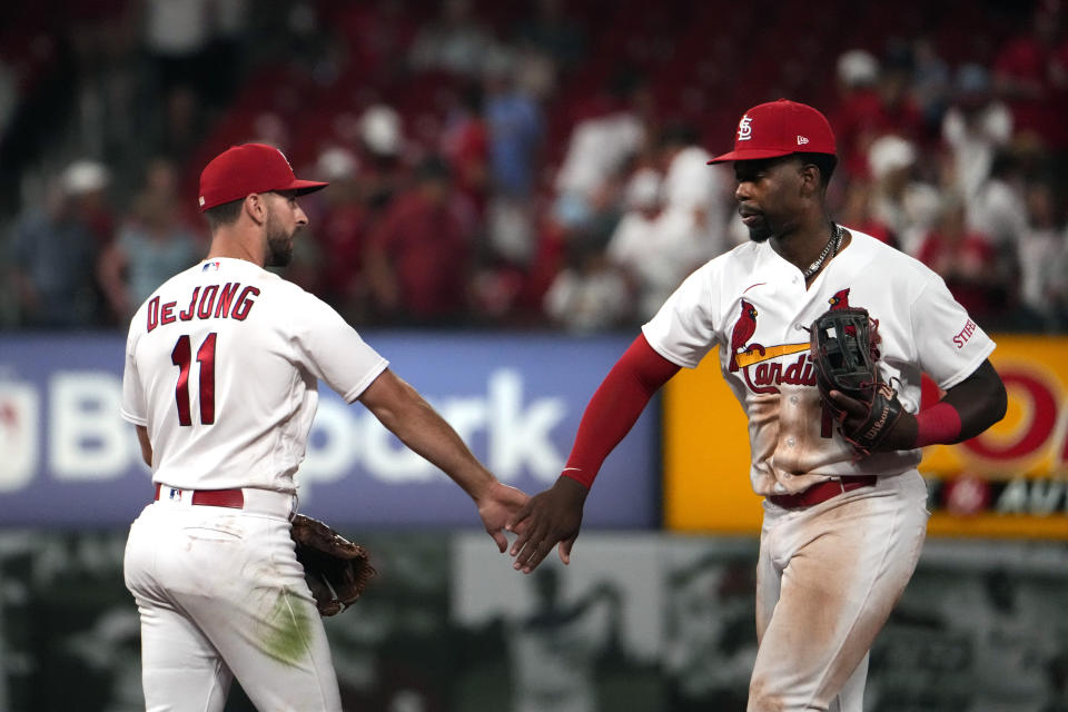 St. Louis Cardinals' Jordan Walker, right, and Paul DeJong (11) celebrate a 7-4 victory over the Cincinnati Reds in a baseball game Friday, June 9, 2023, in St. Louis. (AP Photo/Jeff Roberson)
