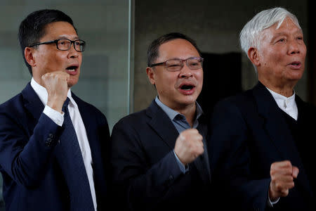 (L-R) Occupy Central pro-democracy movement founders Chan Kin-man, Benny Tai and Chu Yiu-ming chant slogans after found guilty over the Occupy Central protests, also known as "Umbrella Movement", in Hong Kong, China April 9, 2019. REUTERS/Tyrone Siu