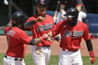 From left to right, Cleveland Indians' Jose Ramirez is congratulated by Yu Chang and Cesar Hernandez after hitting a three-run home run in the fourth inning in a baseball game against the Kansas City Royals, Sunday, July 26, 2020, in Cleveland. (AP Photo/Tony Dejak)