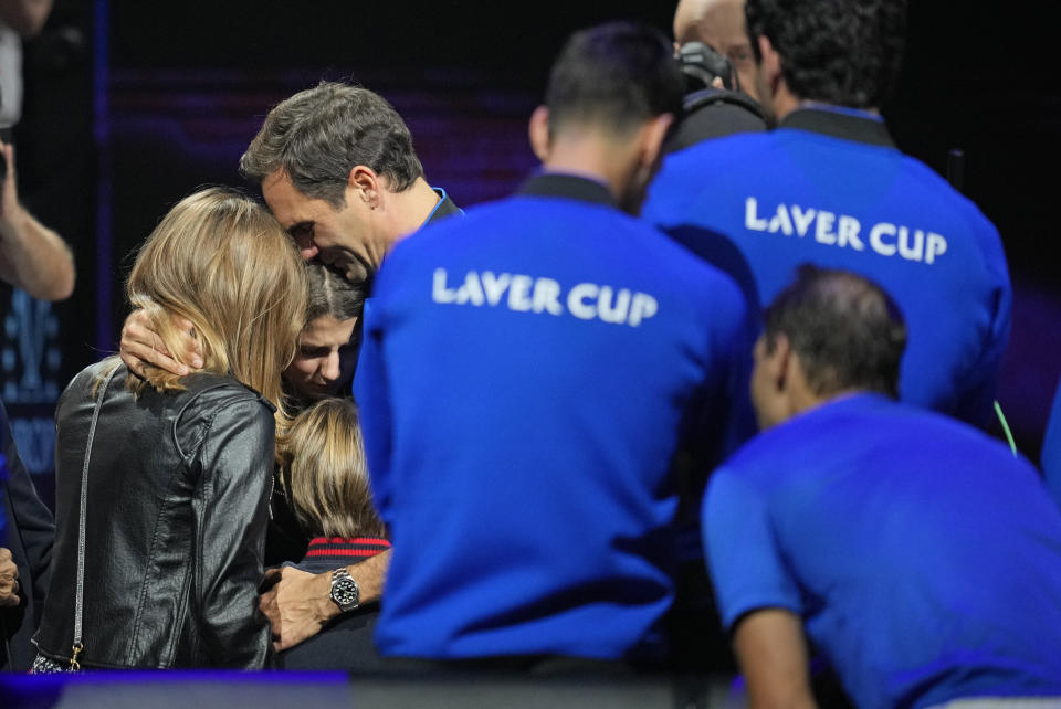 An emotional Roger Federer of Team Europe embraces his wife Mirka and their children after playing with Rafael Nadal in a Laver Cup doubles match against Team World's Jack Sock and Frances Tiafoe at the O2 arena in London, Friday, Sept. 23, 2022. Federer's losing doubles match with Nadal marked the end of an illustrious career that included 20 Grand Slam titles and a role as a statesman for tennis. (AP Photo/Kin Cheung)