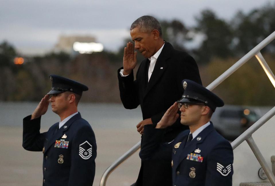 President Barack Obama salutes as he descends the stairs from Air Force One as he arrives Saturday, Jan. 7, 2017, in Jacksonville, Fla. Obama is going to a staff member's wedding. (AP Photo/Alex Brandon)