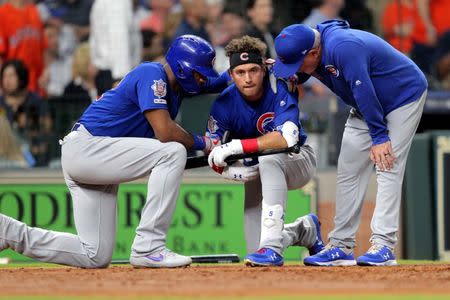 May 29, 2019; Houston, TX, USA; Chicago Cubs center fielder Albert Almora Jr. (5, center) is consoled by right fielder Jason Heyward (22, left) and manager Joe Maddon (70) after a fan was hit by a foul ball during the fourth inning against the Houston Astros at Minute Maid Park. Mandatory Credit: Erik Williams-USA TODAY Sports