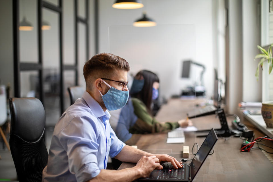 Some workers have returned to offices working in social-distanced spaces. Photo: Getty