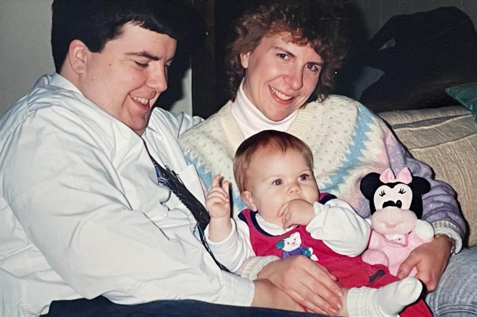 Todd, Wendi and Sarah Eames celebrating a late Christmas after Sarah was released from the hospital, December 1995. The left side of Sarah's head is still visibly swollen from her injury.