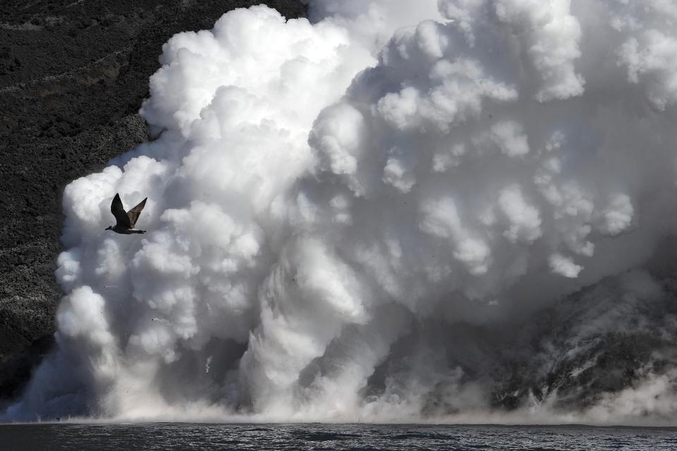 Lava from the Stromboli volcano flows into the sea, on Aug. 9, 2014, in Italy. 