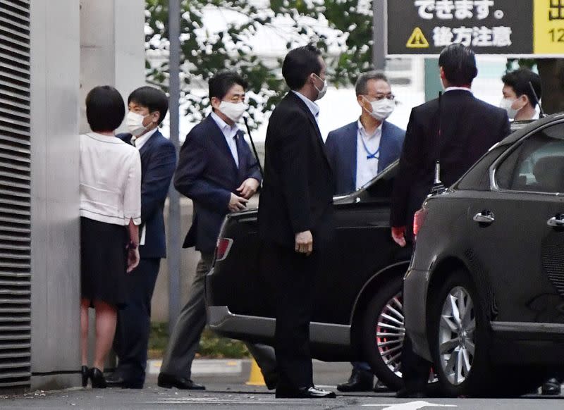 Japanese Prime Minister Shinzo Abe gets into a car as he leaves from Keio University Hospital in Tokyo
