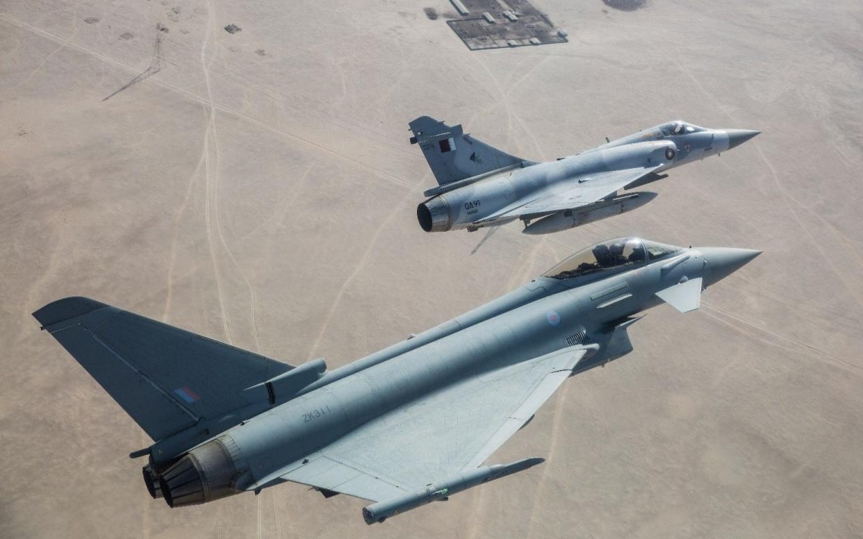 An RAF Typhoon flies in formation with one of Qatar's current jets  - Anadolu