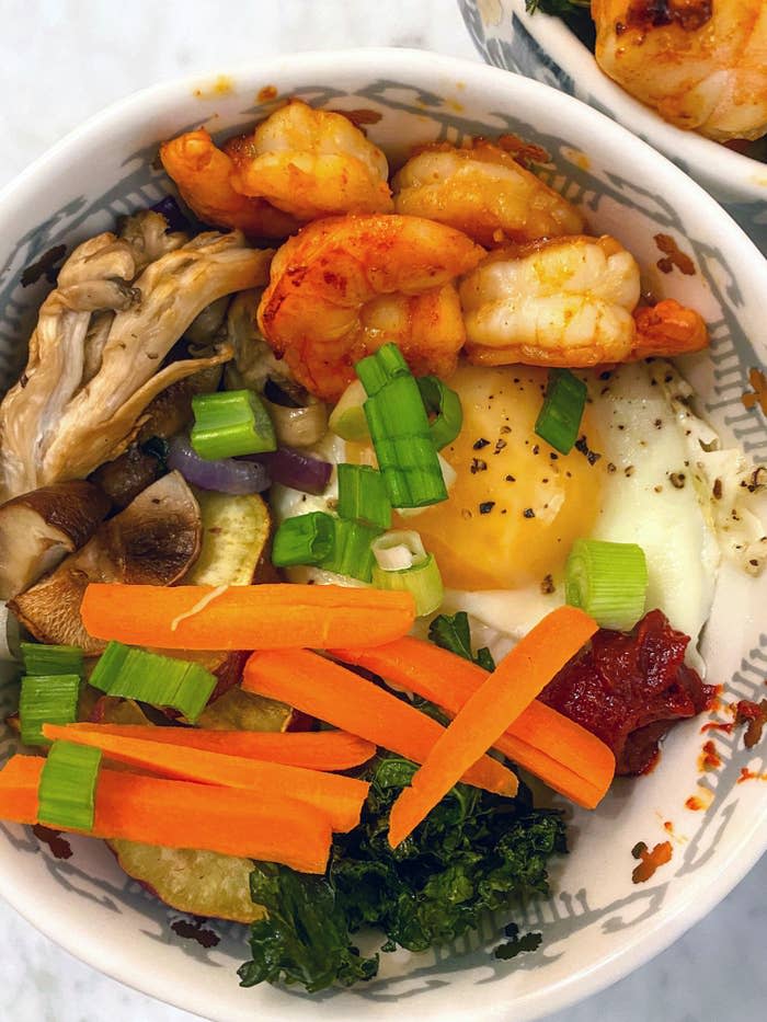 Vegetable and shrimp bibimbap with a fried egg.