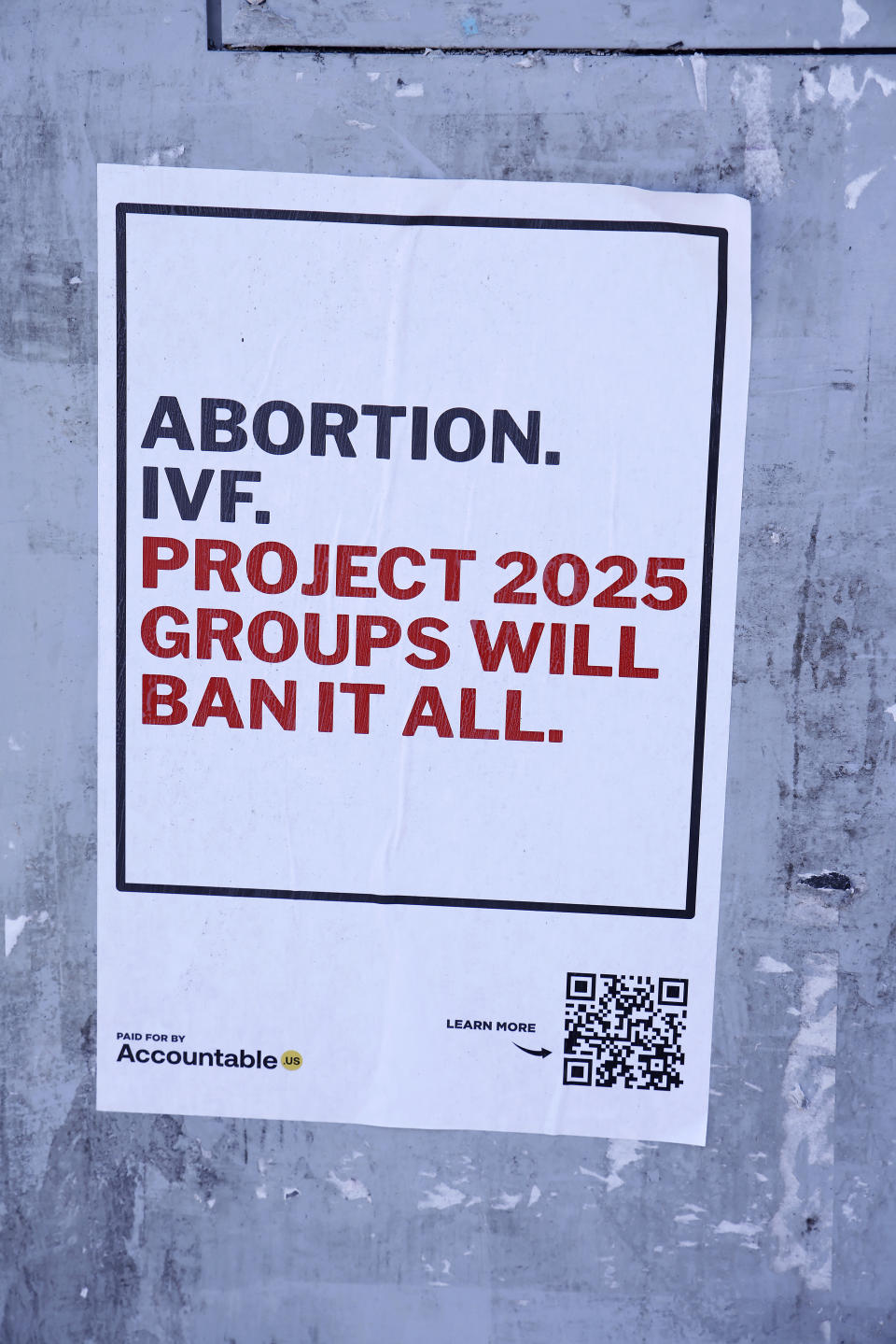 A poster reads: "Abortion. IVF. Project 2025 groups will ban it all." A QR code and the words "Paid for by Accountable" and "Learn more" are at the bottom