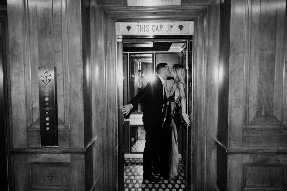 The couple kissing in an elevator