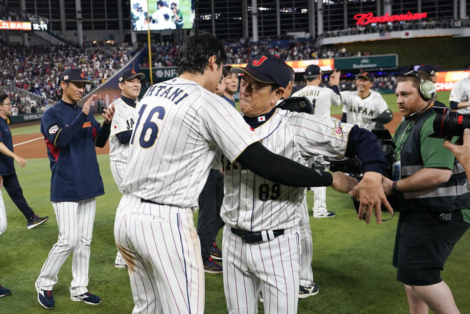 Japan's Shohei Ohtani (16) celebrates with manager Hideki Kuriyama (89) after defeating the United States in World Baseball Classic championship game, Tuesday, March 21, 2023, in Miami. (AP Photo/Wilfredo Lee)