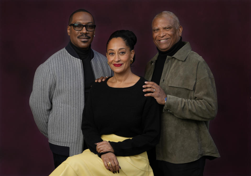 Eddie Murphy, left, and Tracee Ellis Ross, center, cast members in "Candy Cane Lane," and the film's director Reginald Hudlin pose together at the Four Seasons Hotel, Wednesday, Nov. 29, 2023, in Los Angeles. (AP Photo/Chris Pizzello)