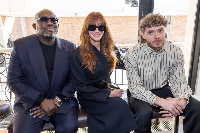 <p>Arnold Jerocki/WireImage</p> (Left to right) Edwards Enninful, Julia Roberts and Jack Harlow sit front row at the the "Les Sculptures" Jacquemus runway show