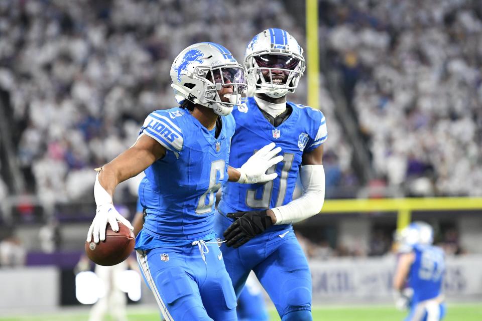 Lions defensive back Ifeatu Melifonwu is congratulated by teammate Kerby Joseph after an interception against the Vikings at the end of the fourth quarter of the Lions' 30-24 win on Sunday, Dec. 24, 2023, in Minneapolis, to clinch the NFC North Division.