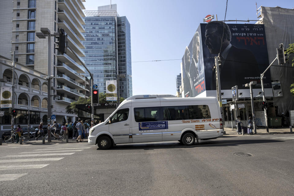 In this photo made on Saturday, Nov. 23, 2019, first ever public bus operated on Shabbat, drives through central Tel Aviv, Israel. Tel Aviv has taken a major step to cement its status as Israel's secular mecca, launching a public transit system operating on Saturdays and redrawing the lines in the Jewish state's culture wars between religious and secular citizens. (AP Photo/Tsafrir Abayov)