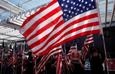 Anti-government protesters hold US flags during a rally at the University of Hong Kong