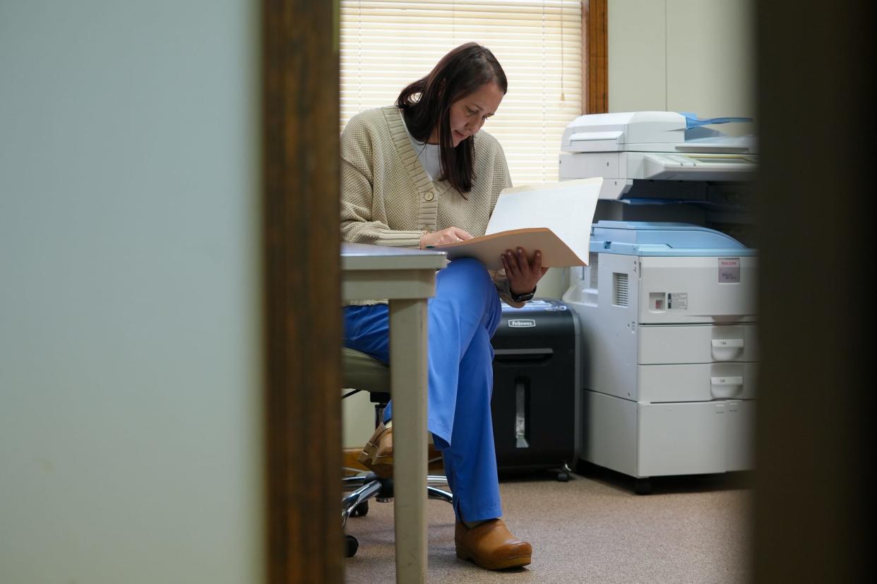 Karolina Ogorek, administrative director of Bristol Women’s Health, reviews paperwork during her shift. The clinic began scheduling evening and weekend appointments to accomodate the influx of patients traveling from conservative states where abortion is restricted or outlawed.