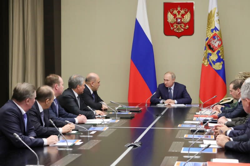 Russian President Vladimir Putin chairs a meeting with members of the Security Council at the Novo-Ogaryovo state residence outside Moscow