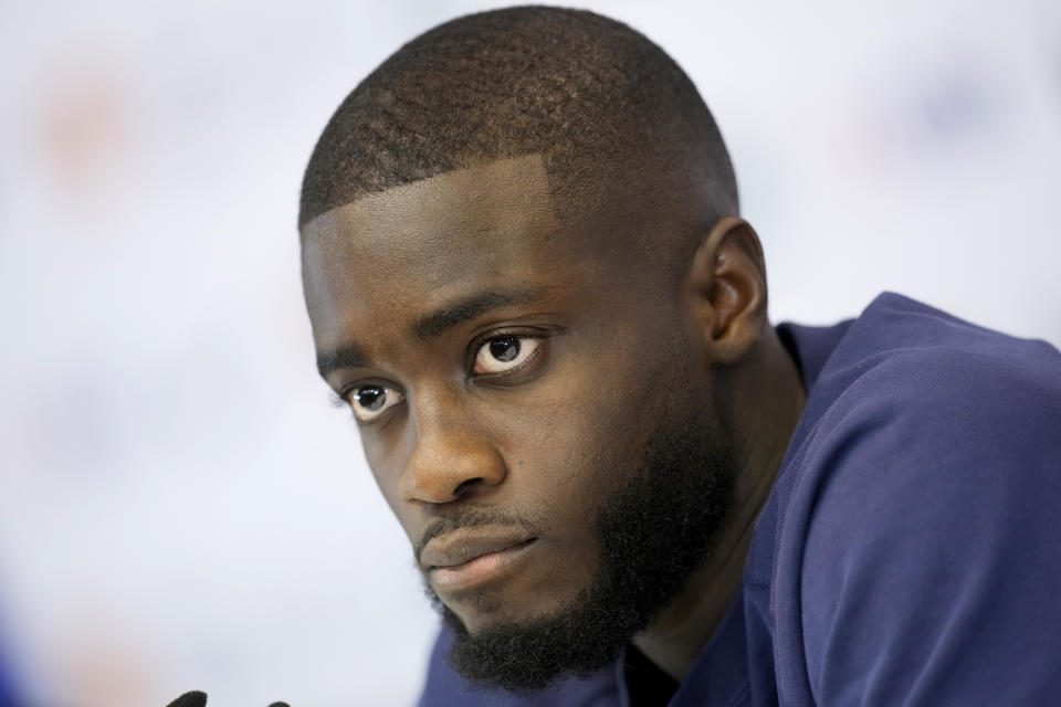 Dayot Upamecano listens to a reporter during a press conference at the Jassim Bin Hamad stadium in Doha, Qatar, Thursday, Dec. 8, 2022. France will play against England during their World Cup quarter-final soccer match on Dec. 10. (AP Photo/Christophe Ena)