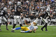 Los Angeles Chargers quarterback Justin Herbert (10) reacts after sliding short of a first down during the first half of an NFL football game against the Las Vegas Raiders, Sunday, Dec. 4, 2022, in Las Vegas. (AP Photo/David Becker)