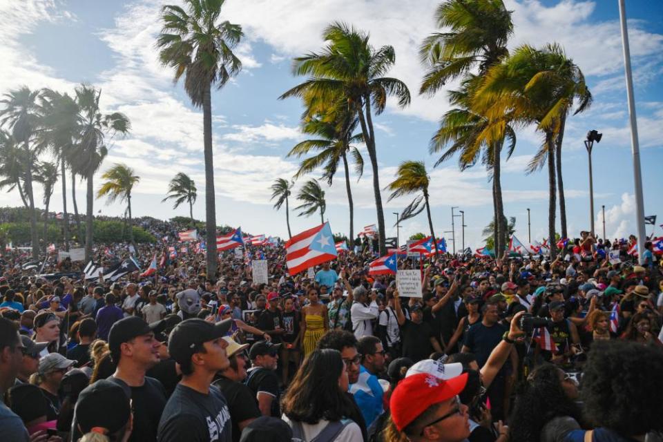 Demonstrators chant and wave Puerto Rican flags in San Juan.