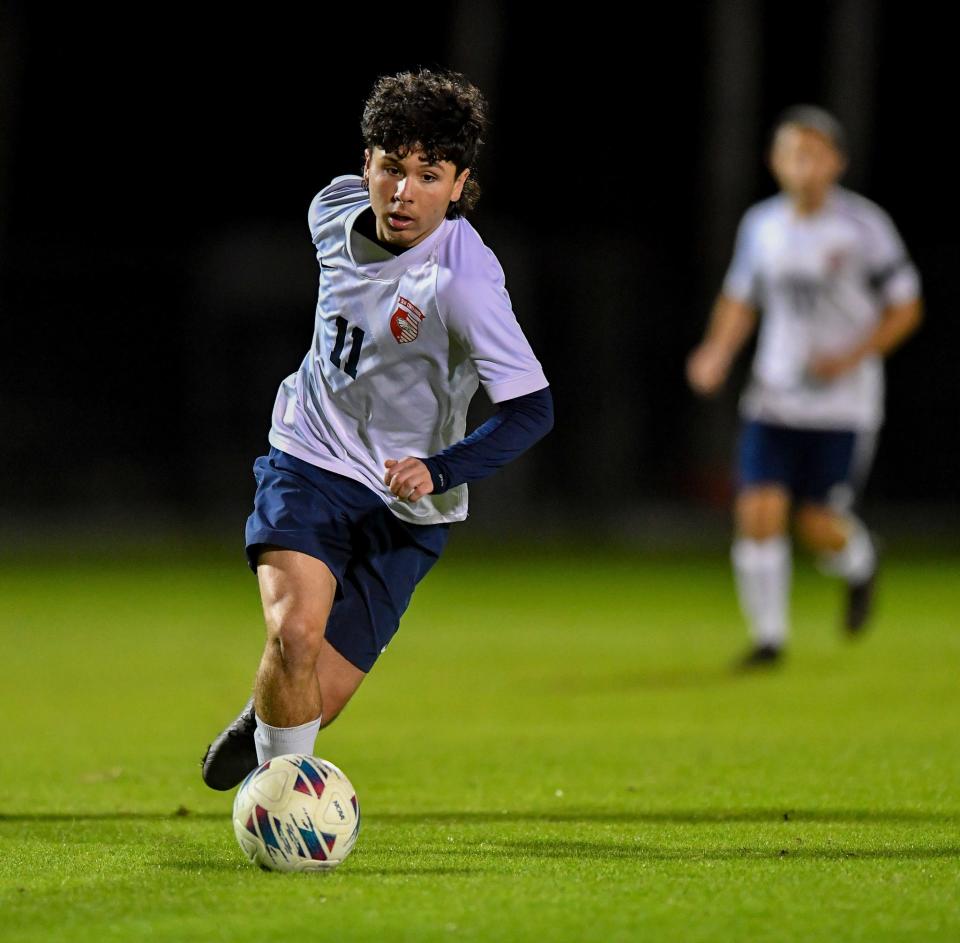 Centennial's Julian Garcia (11) brings the ball up the field in a District 10-7A high school boys soccer final against Jupiter, Wednesday, Jan. 31, 2024, at the South County Regional Sports Complex, in Port St. Lucie.