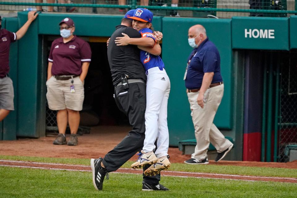 Taylor North's Gavin Ulin gets a hug from coach Rick Thorning after the 5-2 win over Ohio in the Little League World Series championship game in Williamsport, Pennsylvania, on Sunday, Aug. 29, 2021.