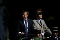 French President Emmanuel Macron and Chief of the Defence Staff French Army General Pierre de Villiers arrive in a command car for the traditional Bastille Day military parade on the Champs-Elysees in Paris, France, July 14, 2017. Picture taken July 14, 2017. REUTERS/Stephane Mahe