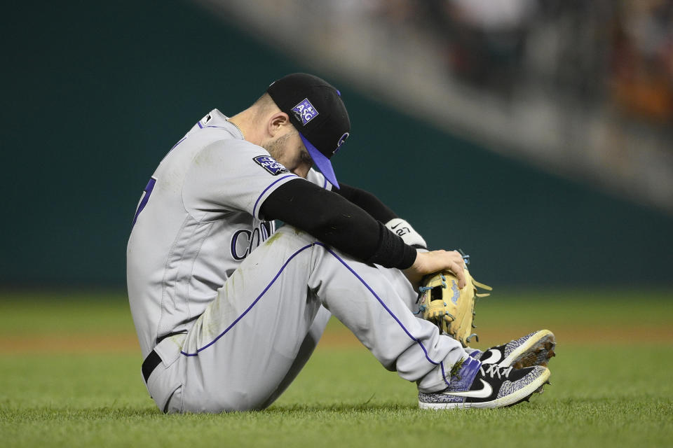Colorado Rockies shortstop Trevor Story pauses on the field after he threw to first but was unable to put out Washington Nationals' Carter Kieboom during the fourth inning of a baseball game, Friday, Sept. 17, 2021, in Washington. (AP Photo/Nick Wass)