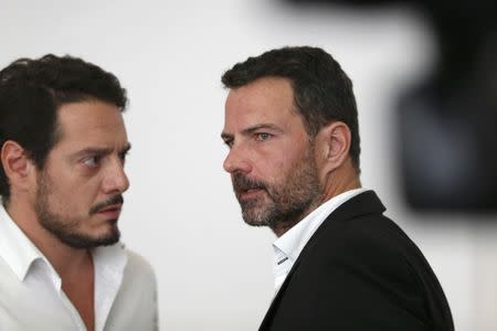 Former trader Jerome Kerviel (R) and his lawyer David Koubbi (L) stand inside the courthouse in Versailles, France, September 23, 2016. REUTERS/Charles Platiau