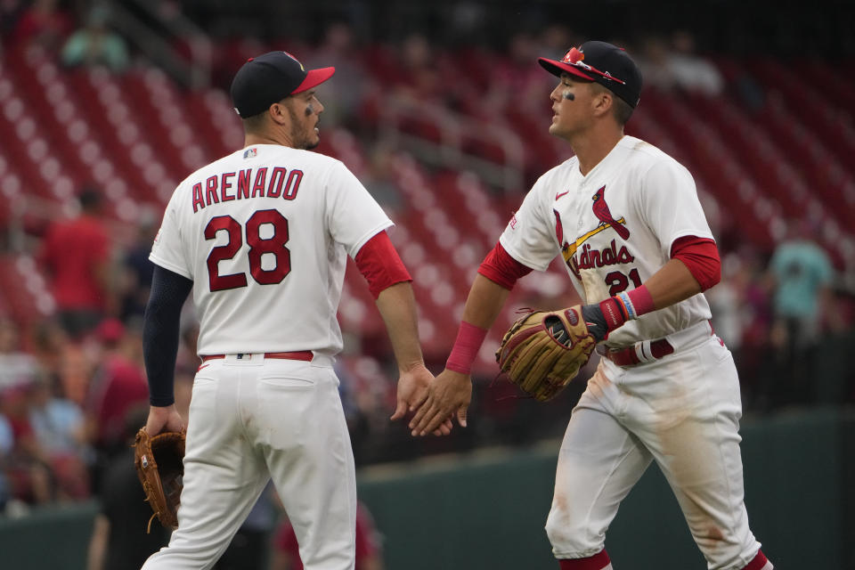 St. Louis Cardinals' Lars Nootbaar (21) and Nolan Arenado (28) celebrate an 8-4 victory over the Washington Nationals following a baseball game Sunday, July 16, 2023, in St. Louis. (AP Photo/Jeff Roberson)