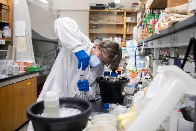 Monica Trujillo, a microbiologist at Queensborough Community College in New York, filters bacteria from a wastewater sample containing traces of coronavirus on Wednesday, Feb. 2, 2022. (Jackie Molloy/The New York Times)