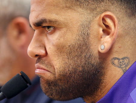 Barcelona's Dani Alves listens to a question during a news conference after a training session at the Barcelona training grounds Ciutat Esportiva Joan Gamper in Sant Joan Despi near Barcelona, Spain, May 25, 2015. REUTERS/Gustau Nacarino