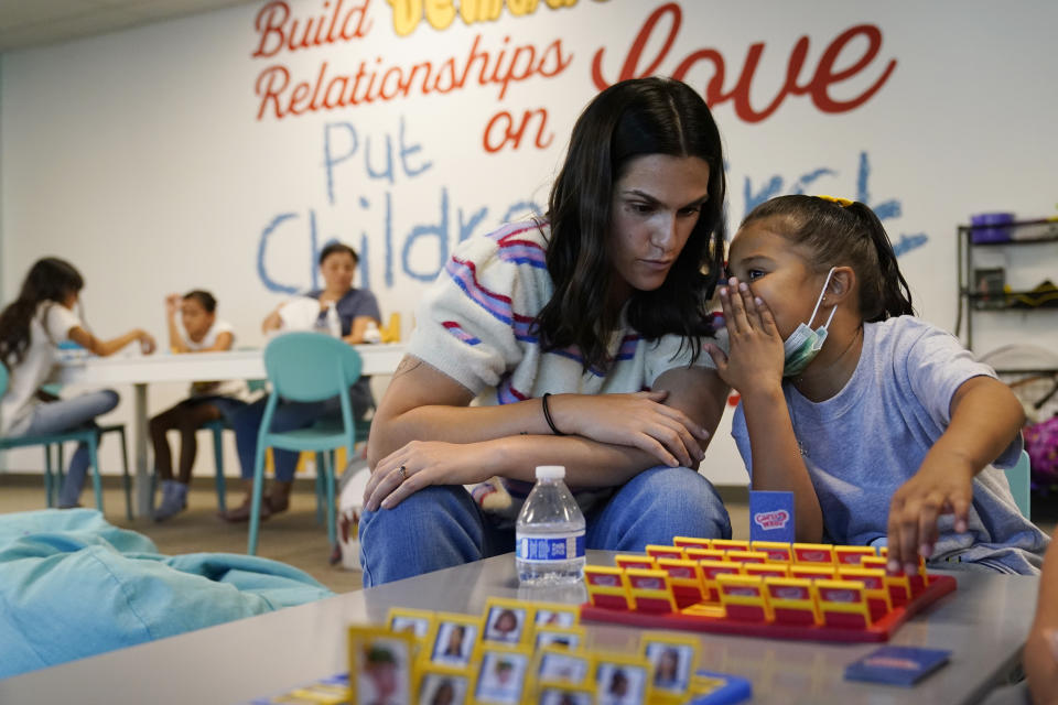 Jorie Das, executive director of Friends of the Children Los Angeles, left, plays a game with Noraa Lopez, 7, at the organization's Antelope Valley office Wednesday, Aug. 24, 2022, in Lancaster, Calif. Billionaire philanthropist MacKenzie Scott donated $44 million to the Oregon-based mentoring organization, which supports children at risk of entering the welfare system by pairing them with a longtime mentor. (AP Photo/Marcio Jose Sanchez)